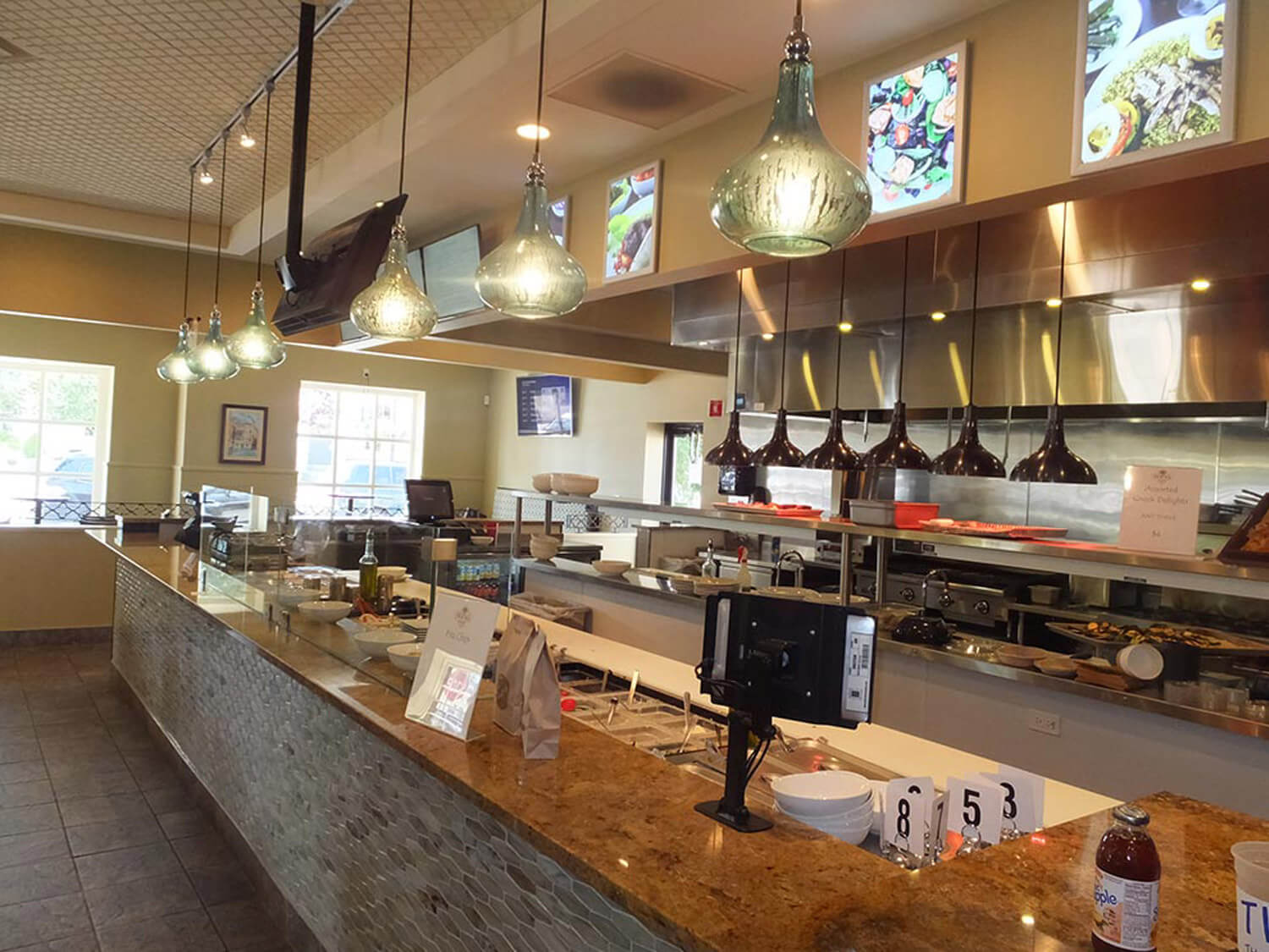 A service bar and kitchen in a brightly lit restaurant